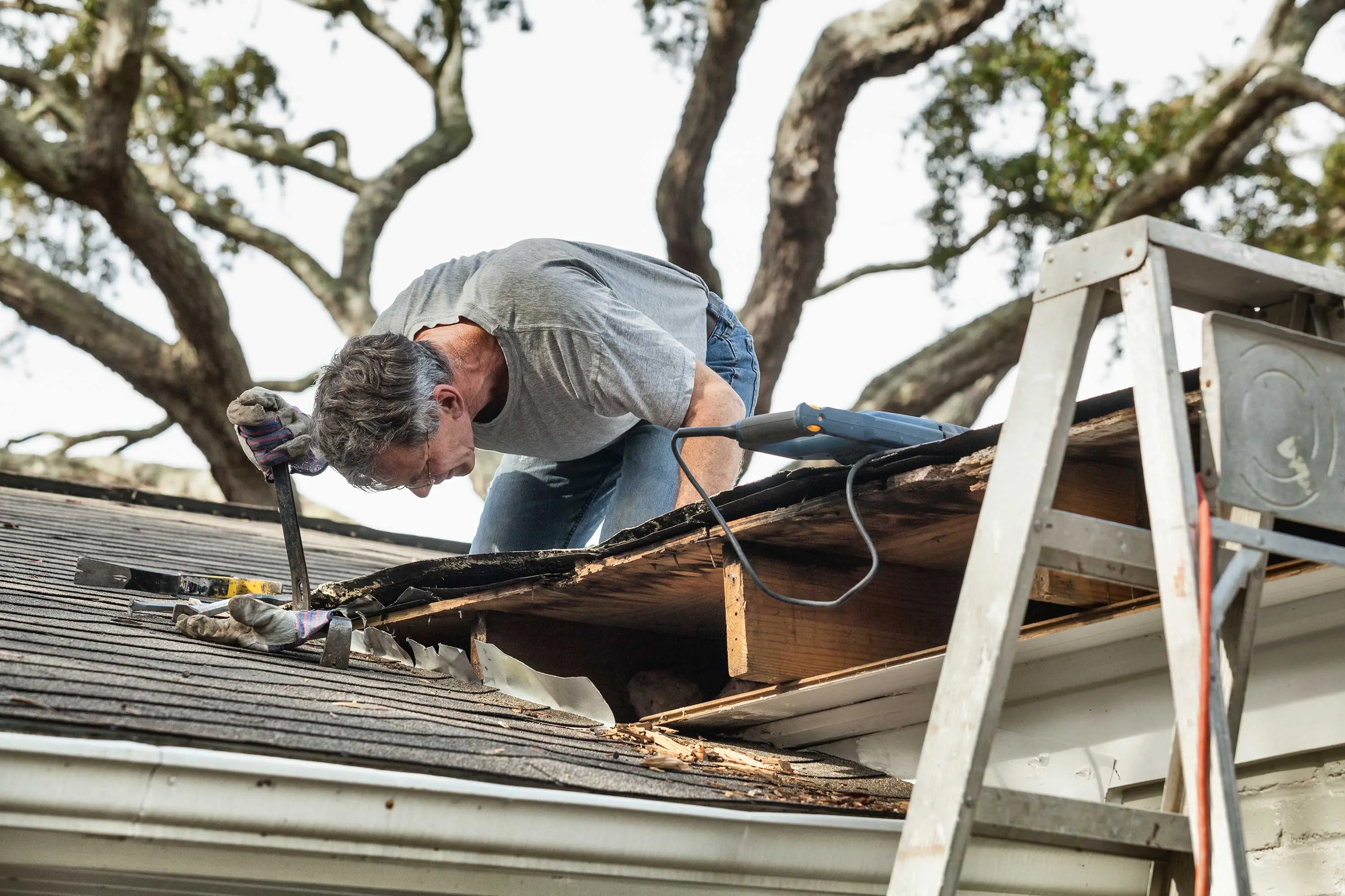 Roofing contractor working on roof